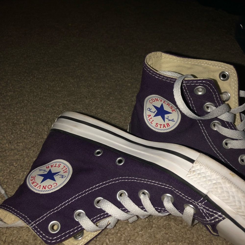 Purple high top converse.